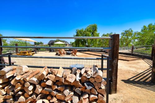 a pile of fire wood in a fence at Peppertree Lane Ranch -- Seven-Acre Ranch in the Heart of Wine Country in Temecula