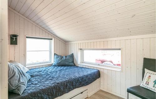 a bed in a tiny house with a window at 3 Bedroom Awesome Home In Hasle in Hasle