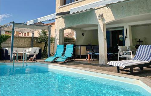 une piscine avec deux chaises et une table dans l'établissement 4 Bedroom Awesome Home In Le Val, à Le Val