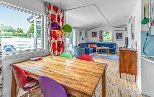a caravan dining room with a wooden table and chairs at Holiday Home Olymposvej in Slagelse