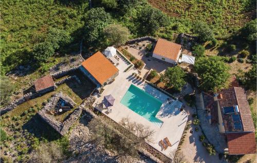 an aerial view of a house with a swimming pool at 2 Bedroom Lovely Home In Punta Kriza in Nerezine
