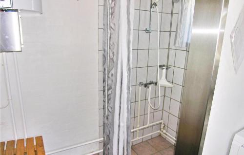 a shower with a shower curtain in a bathroom at Holiday Home B in Fåborg