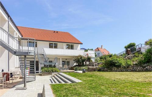 a house with a staircase leading to a yard at Cozy Apartment In Gudhjem With Wifi in Gudhjem