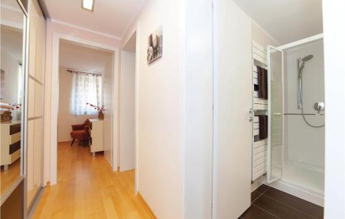 a hallway with white walls and wood floors at 2 Bedroom Nice Apartment In Crikvenica in Crikvenica