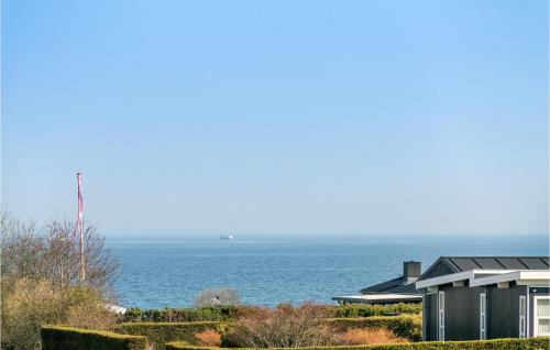 a house with the ocean in the background at Awesome Home In Asperup With Wifi in Asperup
