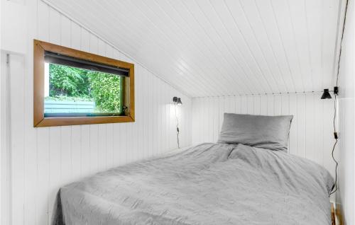 a bed in a white room with a window at Beautiful Home In Jægerspris With Wifi in Jægerspris