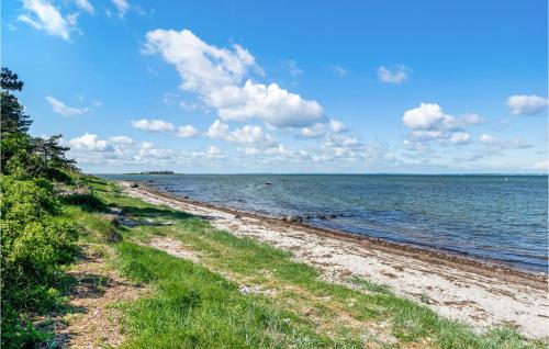 a beach with a group of people in the water at Beautiful Home In Jægerspris With Wifi in Jægerspris