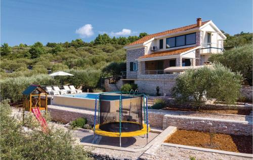 a home with a swimming pool and a house at Beautiful Home In Tankaraca With Outdoor Swimming Pool in Vela Luka