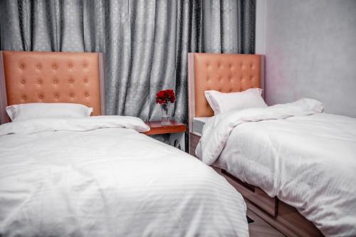 two beds sitting next to each other in a bedroom at Laxmi Homestay with main square view in Bhaktapur