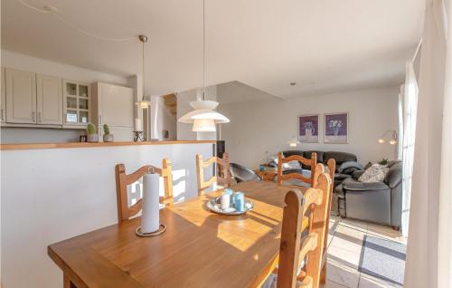 a dining room and kitchen with a table and chairs at Holiday Home Strandgårdsvej Iv in Bro