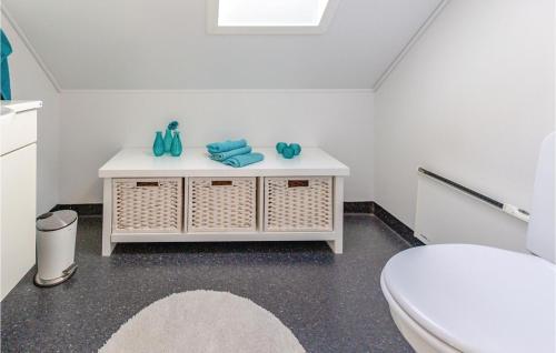 een witte badkamer met een toilet en een wastafel bij 3 Bedroom Lovely Home In Brenderup Fyn in Bro
