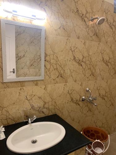 a bathroom with a sink and a mirror at AS Garden Villa in Ranipet