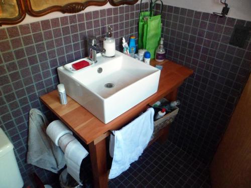 a bathroom sink on a wooden table with towels at Un Viston Modern Mountain Home in San Martín de los Andes