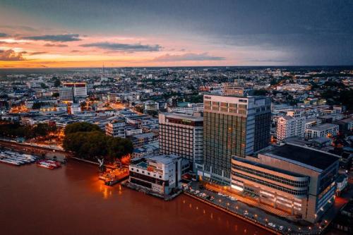 a view of a city with a river and buildings at Kingwood Hotel Sibu in Sibu