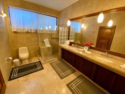 a bathroom with a toilet and a sink and a mirror at Beautiful Residence in Marina, Vallarta in Puerto Vallarta