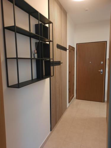 a hallway with black shelves and a door at Apartment - Golden Fox 18 - Pohorske terase in Pohorje