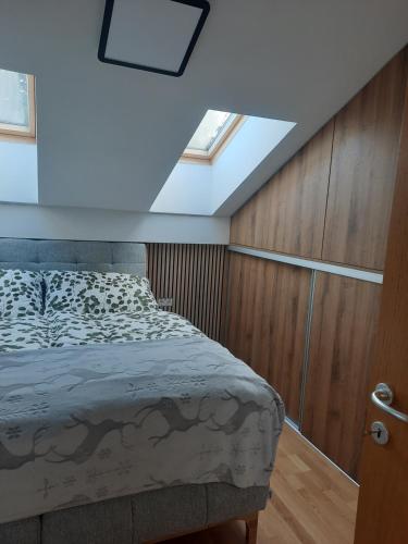 a bedroom with a bed and a skylight at Apartment - Golden Fox 18 - Pohorske terase in Pohorje