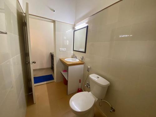 a small bathroom with a toilet and a sink at 2 Beds Affordable Island View with swimming pool in Chorao