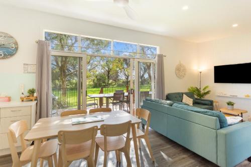 a living room with a couch and a table at Isla Villa, Cowes, Phillip Island. in Cowes