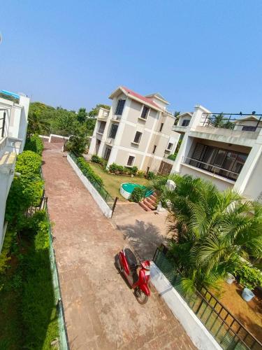 a motorcycle parked in front of a house at The Blue View - sea view villas in Ratnagiri