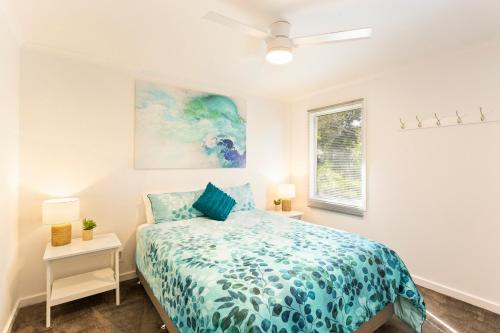 a bedroom with a bed and a window at Isla Villa, Cowes, Phillip Island. in Cowes
