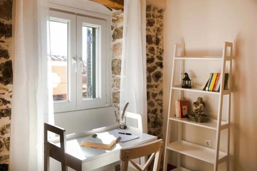 a room with a desk and a window and a book shelf at Alia House in Doukádes