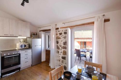a kitchen with a table and a dining room at Alia House in Doukádes