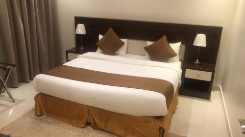 a bedroom with a large bed with white sheets and pillows at فيولا للشقق المخدومة in Riyadh