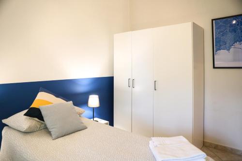 a bedroom with a white cabinet and a bed at Materdays 24 in Naples