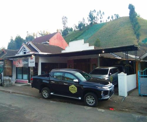 a black truck parked in front of a building at Pak Tasrip Homestay in Bromo