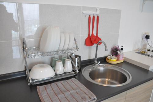a kitchen counter with a sink and a kitchen utensils at Bayu Bangi in Bangi
