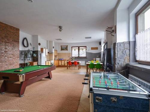 a living room with a pool table and a tv at Willa Gorce in Ostrowsko