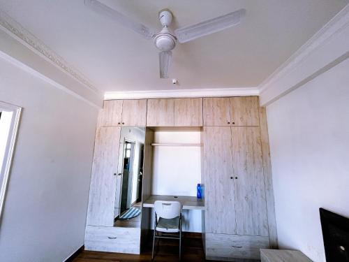 a room with a table and a ceiling fan at RVR Home - Beautiful Rooms in Bangalore