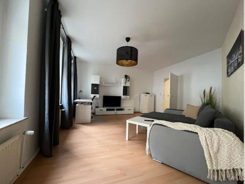 - un salon avec un canapé et une table dans l'établissement R&L Apartment Uhlandstrasse, à Leipzig