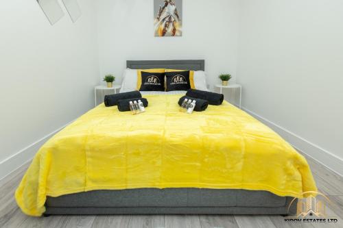 a large yellow bed in a white room at Hermes Apartment - The Messenger of Town in Southampton