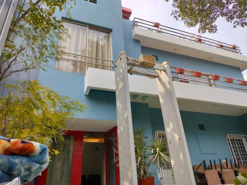 a blue and white building with a balcony at Divine Inn Couple Friendly Hotel near Sector 51 Metro Station in Noida