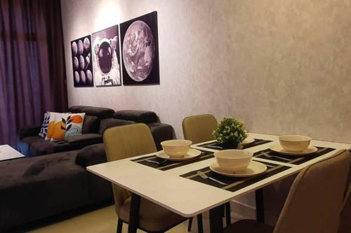 a living room with a table and a couch at Cozy Spacious Home 2 BR SKS Habitat Larkin JB in Johor Bahru