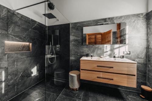 a bathroom with a sink and a shower at Chalet Tannalm in Bad Kleinkirchheim