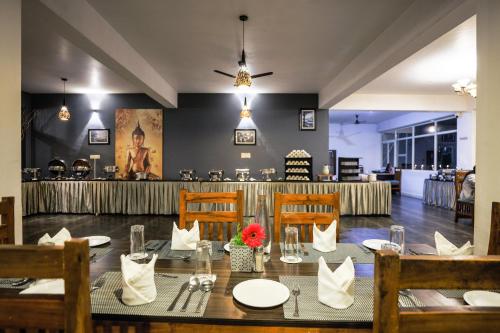 a dining room with a table and chairs at The Blossom Resort - Chikmagalur in Chikmagalūr