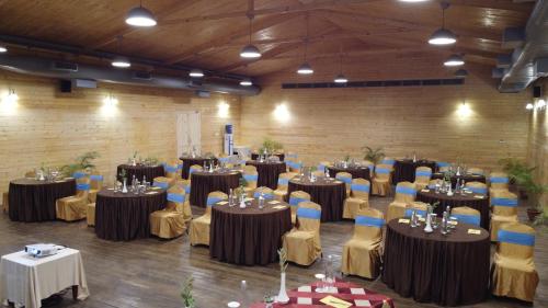 a large room with tables and chairs and tablesktop at Lotus an Eco Resort Konark in Konārka