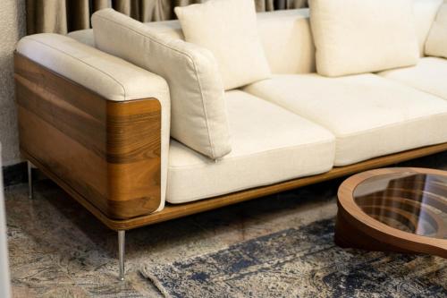 a living room with a white couch and a coffee table at YANNA APARTMENT BY KHALIQUES in Abuja