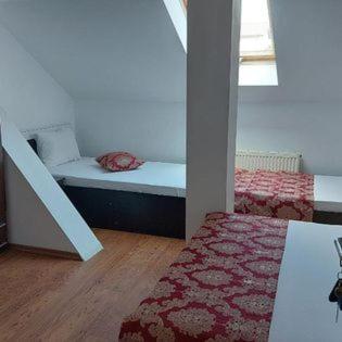 a room with a bed and a red rug at Ionela in Costinesti