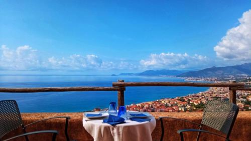 a table with chairs and a view of the ocean at Blu Oltremare in Borgio Verezzi
