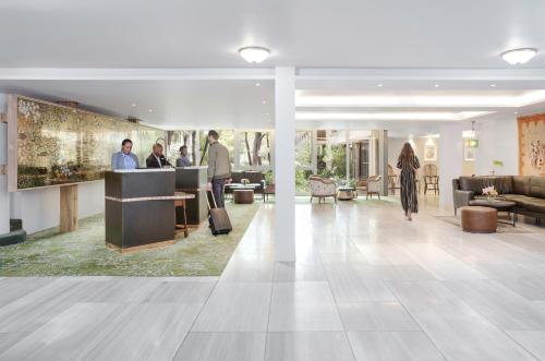 a rendering of the lobby of a building with people at Vineyard Hotel in Cape Town