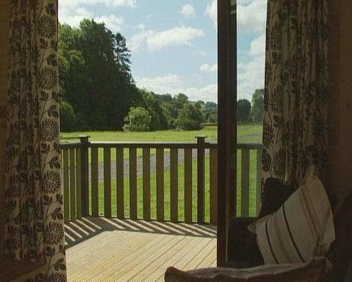 a balcony with a view of a view of a field at Peel Lodge - Parmontley Hall Lodges in Hexham