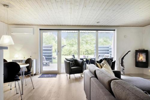 a living room with a couch and chairs at Sommerhus ved Vesterhavet in Ulfborg