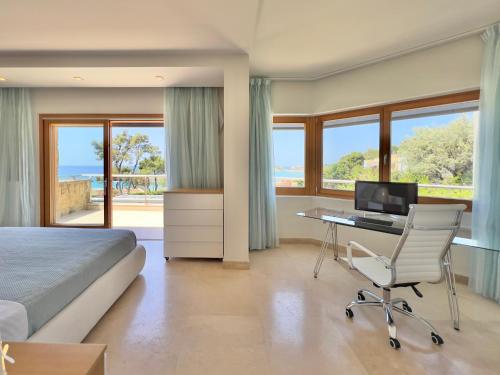 a bedroom with a bed and a desk with a computer at Luxury Villa in Sani, Halkidiki, Greece in Sani Beach