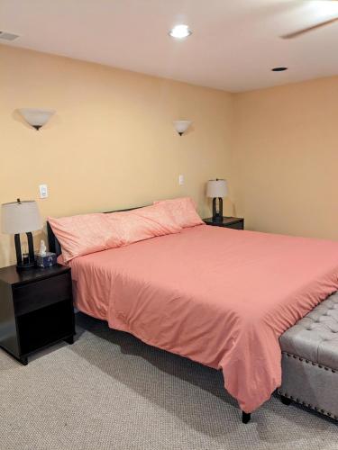 a bedroom with a pink bed and a couch at Chicago Home 6 bd 4 ba home with 2 car garage parking in Chicago