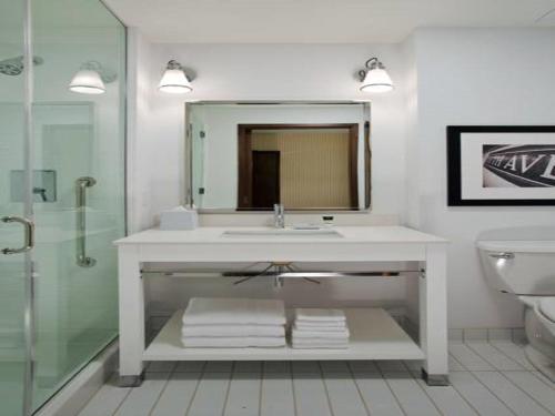 a bathroom with a sink and a mirror and a toilet at The Crossroads Hotel - Newburgh in Newburgh