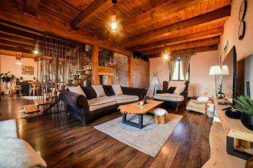 a living room with a couch and a table at Rustic dream MIA in Zlatibor